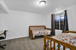 Bedroom featuring baseboards and carpet