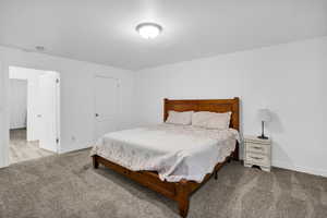 Bedroom with baseboards and carpet