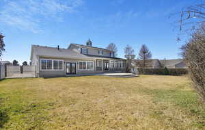 Rear view of property with a patio area, french doors, a yard, and fence