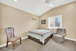 Carpeted bedroom featuring recessed lighting, baseboards, a ceiling fan, and vaulted ceiling