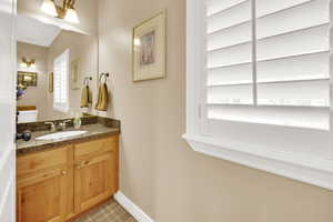 Half bath with vanity and baseboards