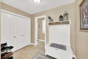 Mudroom with baseboards and light tile patterned flooring