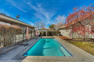View of pool featuring a gazebo, a fenced in pool, and a fenced backyard
