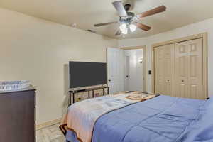 Bedroom with visible vents, ceiling fan, baseboards, light wood-style floors, and a closet