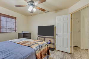 Bedroom featuring visible vents, light wood-style floors, and a ceiling fan