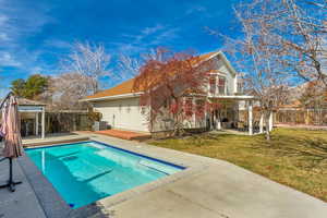 View of pool with a patio, a fenced in pool, a fenced backyard, central air condition unit, and a lawn