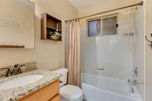 Bathroom with vanity, toilet, and shower / bath combo
