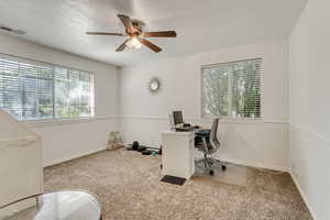 Office featuring visible vents, carpet floors, a textured ceiling, and baseboards