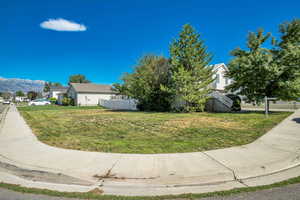 View of yard featuring a mountain view, stairs, and fence