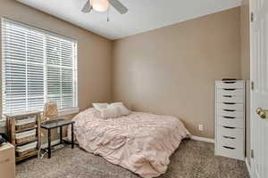 Bedroom featuring carpet flooring, a ceiling fan, and baseboards