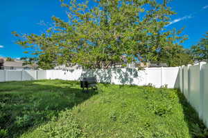 View of yard with a fenced backyard
