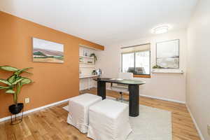 Office area featuring baseboards and light wood finished floors