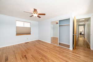 Unfurnished bedroom with a closet, light wood-style flooring, a textured ceiling, and baseboards