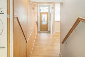 Foyer featuring light wood finished floors and baseboards