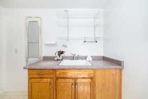 Bathroom featuring baseboards and vanity