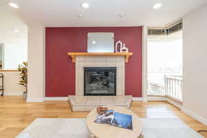 Living room with baseboards, wood finished floors, and a fireplace