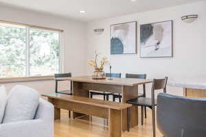 Dining room featuring light wood finished floors and recessed lighting