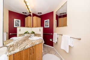 Bathroom featuring tile patterned floors, vanity, and baseboards