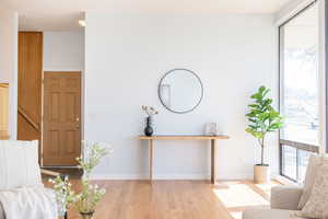 Sitting room with baseboards and hardwood / wood-style floors