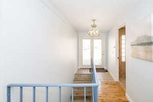 Foyer entrance with light wood-type flooring and baseboards