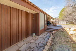 Exterior space with fence and a wooden deck