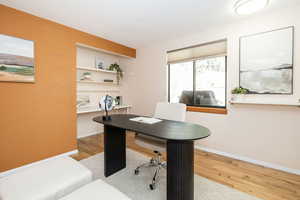 Office space with wood finished floors and baseboards