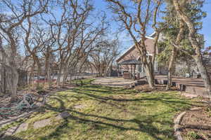 View of yard with a gazebo, a wooden deck, and fence