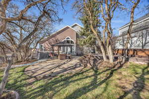 Exterior space with a patio, fence, a lawn, and stucco siding