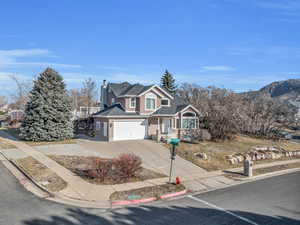 Traditional-style house with concrete driveway and a chimney