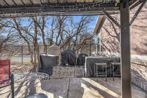 View of patio / terrace featuring area for grilling and fence