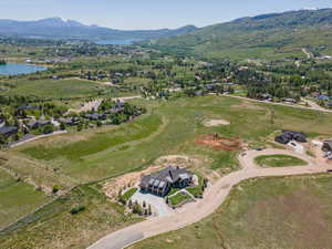 Aerial view of property and surrounding area featuring a water and mountain view