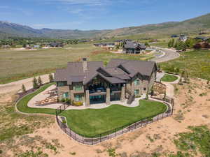 Aerial view of property and surrounding area with a mountain backdrop