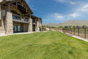 View of yard featuring a mountain view, a balcony, stairway, and a patio area