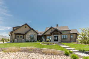 Craftsman-style house with board and batten siding and a front lawn