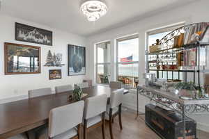 Dining area featuring a water view and wood finished floors