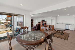 Dining area with light wood-type flooring and recessed lighting