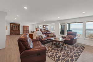 Living room featuring light wood-style floors, baseboards, and recessed lighting