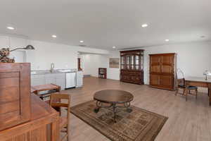 Living room with visible vents, light wood finished floors, and recessed lighting