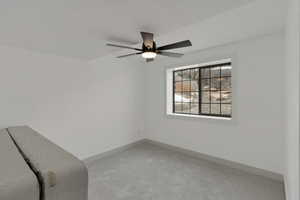 Unfurnished bedroom featuring carpet floors, a ceiling fan, and baseboards