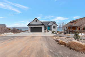 View of front of house featuring concrete driveway and a garage