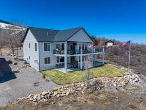 Back of property featuring central air condition unit, a patio, roof with shingles, and a lawn