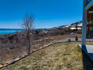 View of yard with a water and mountain view
