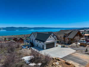 Birds eye view of property featuring a water and mountain view