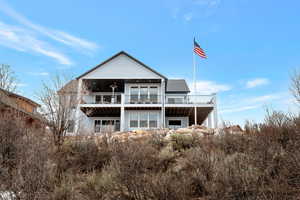 Back of property with a balcony