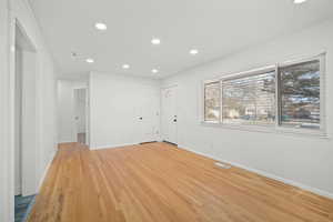 Spare room with recessed lighting, visible vents, baseboards, and light wood-style floors