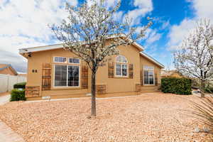 Back of house featuring stucco siding and fence