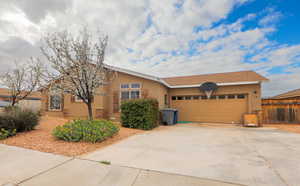 Ranch-style house with stucco siding, a garage, and concrete driveway