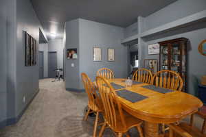 Dining room featuring baseboards and carpet floors