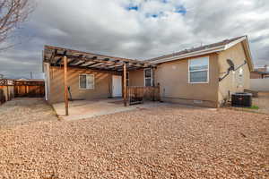 Back of property with cooling unit, a patio area, fence, and crawl space