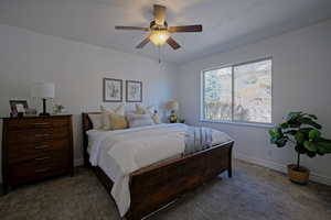 Carpeted bedroom with ceiling fan and private mountain views